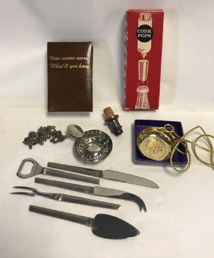 The Home Bartenders Lot: Italian stainless steel bartending tools (6); Cork Pops in original box; two French wine tasting Tastevins - silver and gilt; and a silver wine pourer. 8" to 2-3/4"