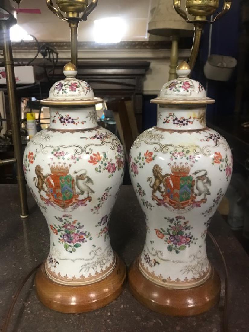 Pair Edme Samson Ginger Jar Lamps: 20th C. French Edme Samson Ginger Jars on wood stands. These jars are not drilled but placed upon the stands. The lids have been glued closed. Handpainted and raised white decorations with a crest, li