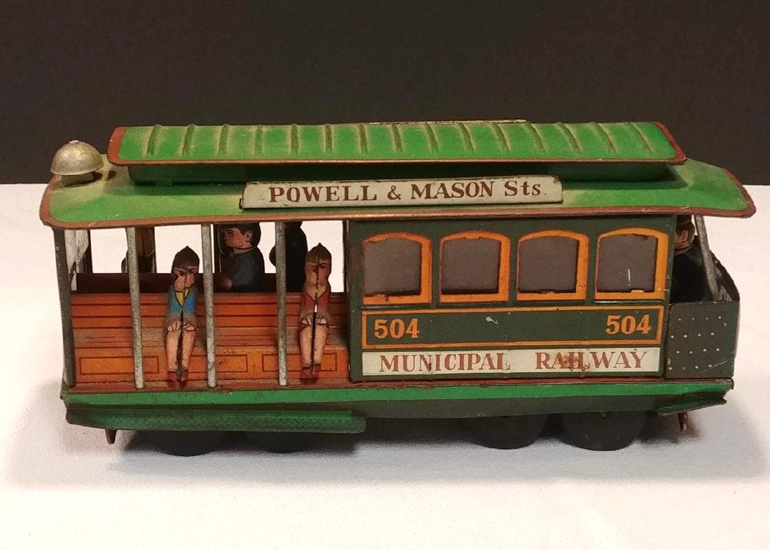 Tin Railroad Street Car: Made in Japan. Trade Mark (with symbol) Tin figures standing and seated for the ride. Reads, Bay & Taylor, Sts. Municipal Railway, 504. Powell & Market. Bay & Taylor. 7-1/4" long