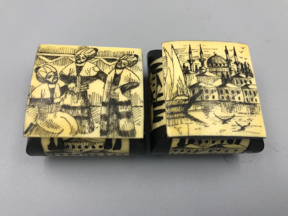 Pr. Middle Eastern Camel Bone Trinket Boxes: Two "scrimshaw style" painted camel bone boxes with scenes of water, birds, boats and cityscape. Red interior lined. Removable lid. 1-1/4" square