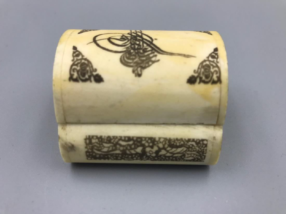 Middle Eastern Camel Bone Trinket Box: Black painted dome lidded pin hinged box with scrollwork decorations and stylized flowers at the sides and back. Red velvet interior and exterior lined floor. 1-3/4" L x 1-3/4" W x 1-1/2" H