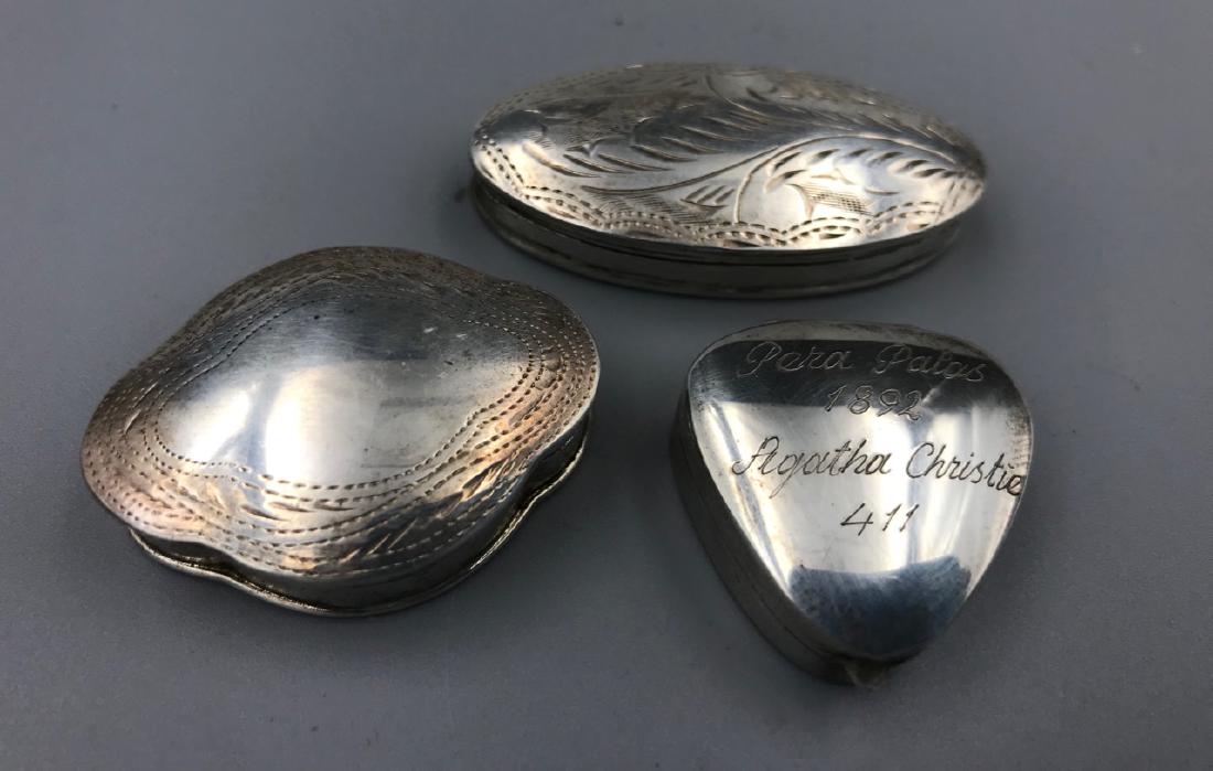 Sterling Silver Pill Boxes (3): Three different shaped. All etched. Heart shaped box marked at top, "Pera Palas 1892, Agatha Christie 411."Marked 925. 2" W; 1-1/2" W; 1" W