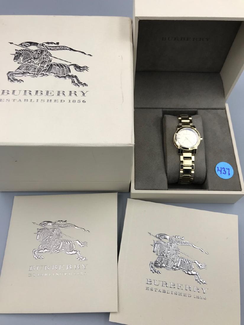 Burberry Ladies Watch: In original box. On back of watch it reads, BU9227, 50M / 165 feet, Burberry, Swiss made Sapphire Crystal, 51200. Unused.
