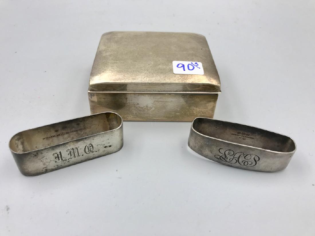 Poole Sterling Box, Two Napkin Holders: Sterling Silver wood lined box (one small dent as shown in photo.) Two sterling silver napkin rings, both are monogrammed. One is Gorham. 3-1/2" l x 4" D x 1-3/4" H; 2-3/4" L each napkin ring