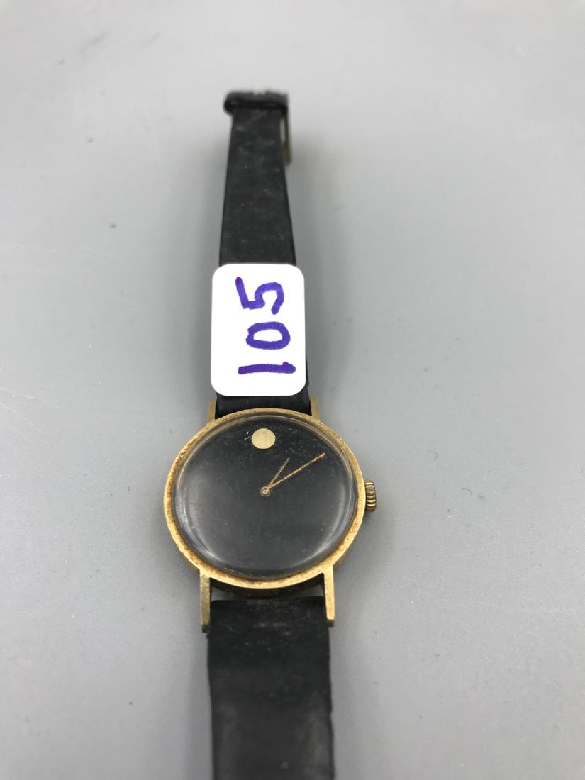 Movado Zenith 14K Gold Ladies Watch: Movado 14K Gold Zenith Museum Dial Swiss mechanical black watch. Leather band marked Hirsch Nappcalf. 1" D to the stem.