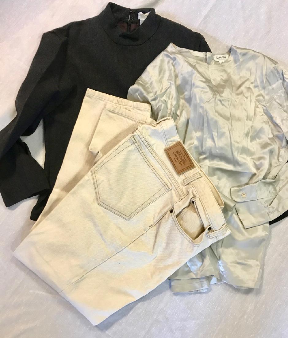 Lot of Vintage Calvin Klein Clothing (3): Gray silk blouse; wool pull over suit jacket with back zipper; off white jeans. All in need of Dry Cleaning.