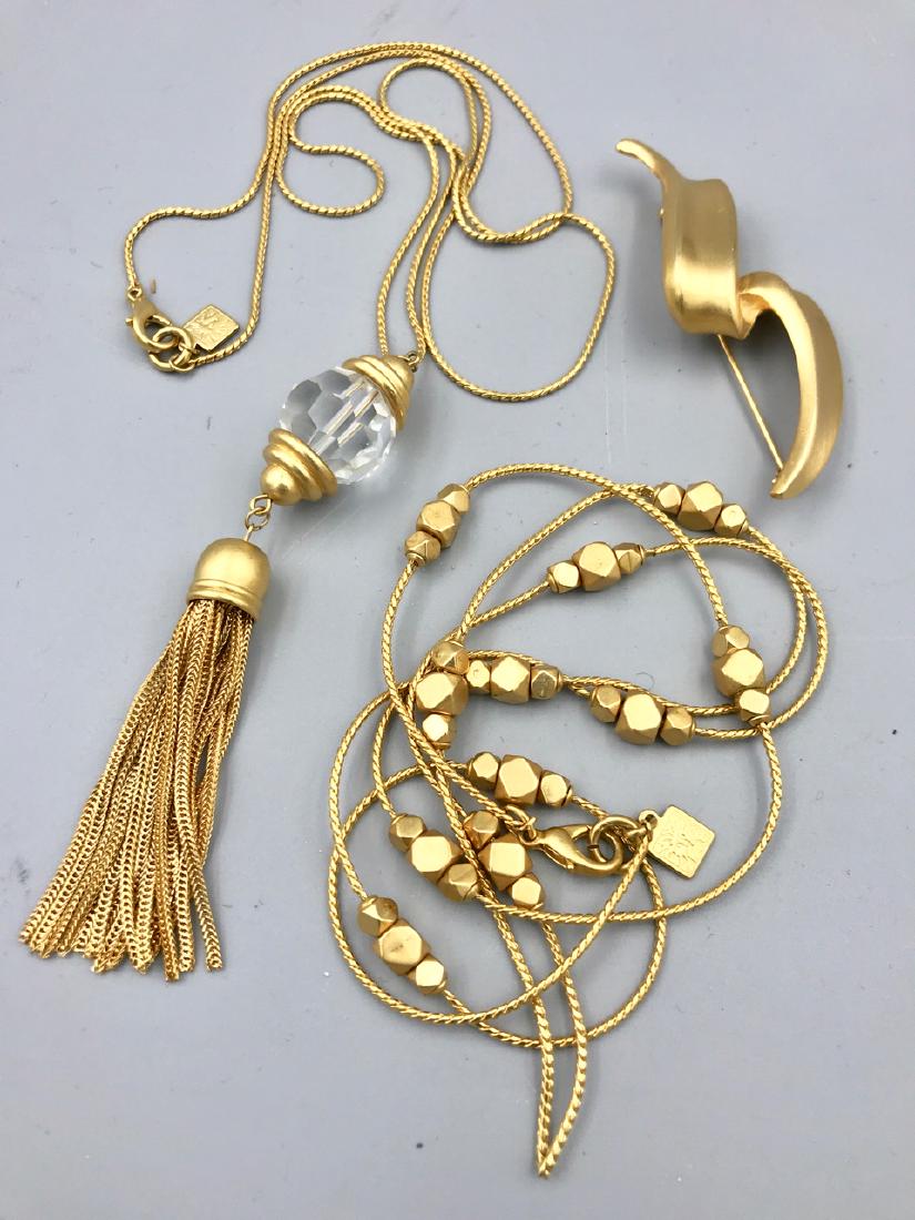 Anne Klein Jewelry Lot: Pendant necklace with crystal and tassle; long necklace with gold beads; and a ribbon pin. 20" L; 17-1/2" L; 3" L