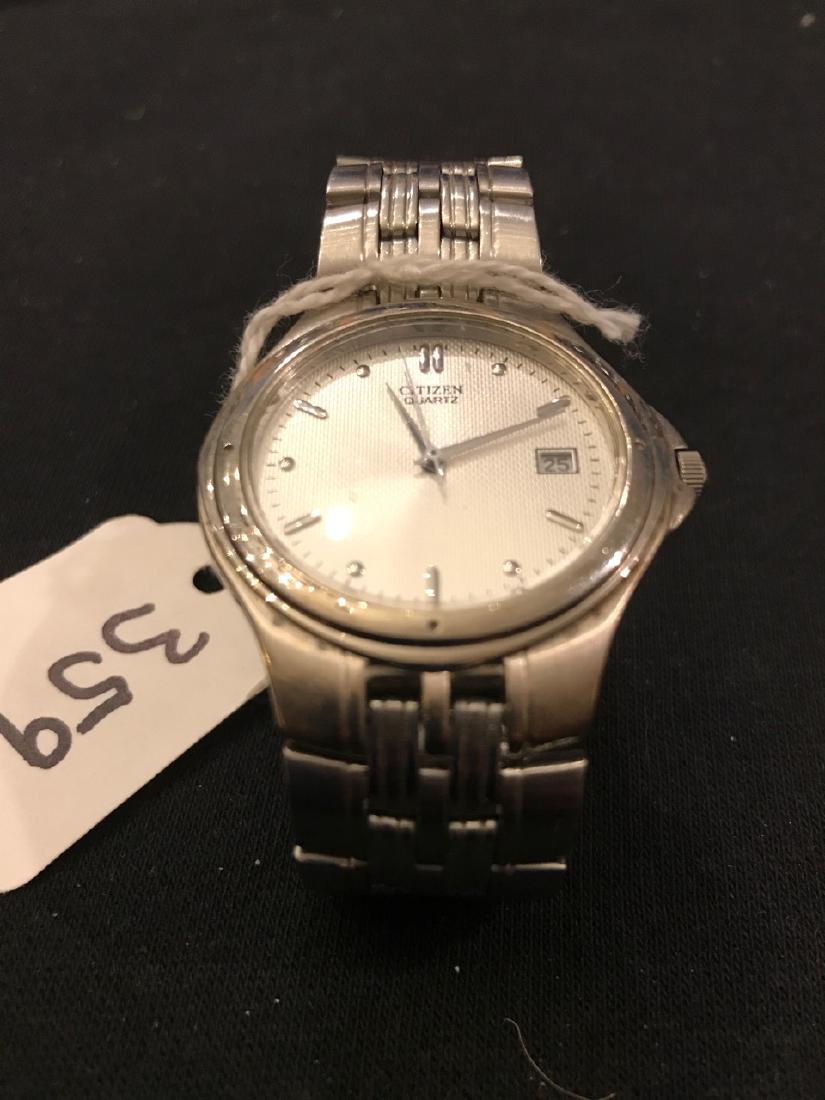 Citizen Quartz Mens Watch: Citizen Watch Co. Water resistant. Window for date. Tick marks on dial. Stainless steel band.