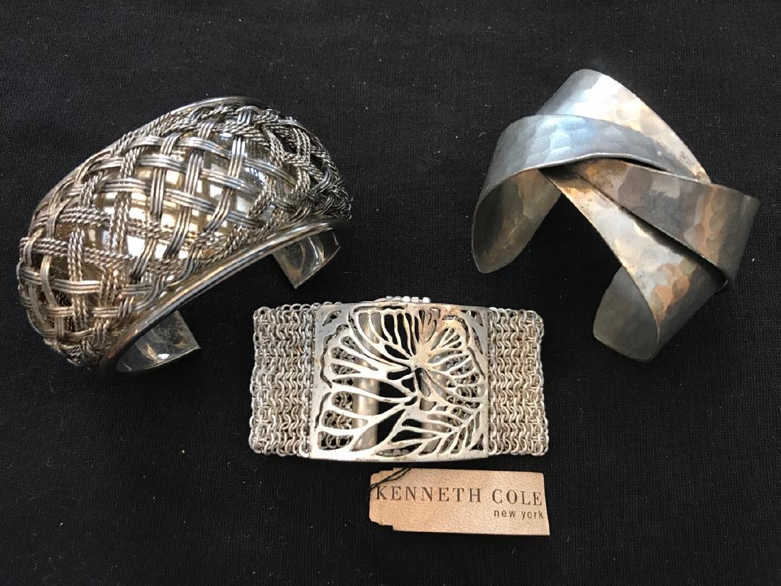 Silvertone Bracelet Lot inc. Kenneth Cole (3): Three silvertone bracelets including a new with tag Kenneth Cole; a basket weave cuff; and a hand hammered cuff. 3" D; 3-1/2" D; 3" D