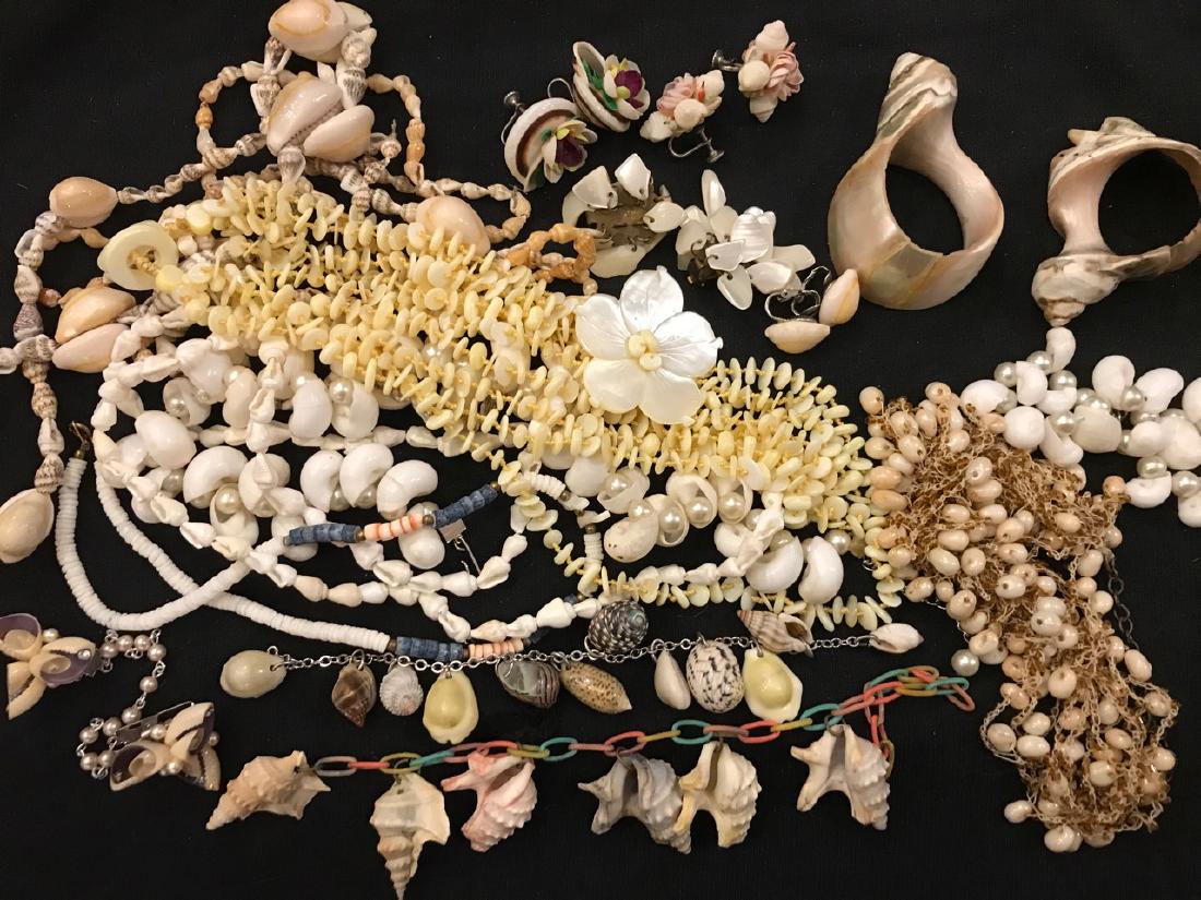 Large Lot of Sea Shell Jewelry: 7 - Necklaces; 3 - Bracelets; 1- Sweater Clip; 4 - Pair of Earrings. Also included in the lot are two shell napkin rings. Varying sizes and decades.