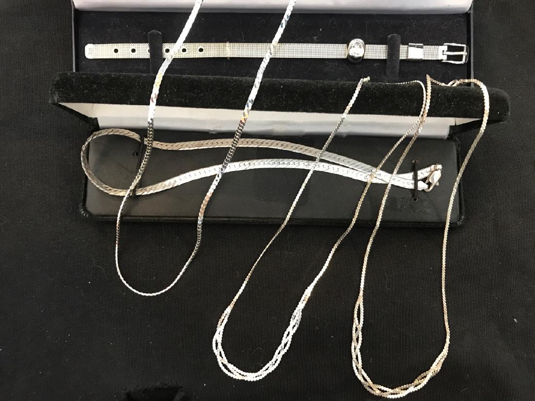 Sterling Silver Jewelry Lot (5): Sterling silver belt style bracelet with crystal new in box; sterling silver flat chain necklace; two braided sterling silver necklaces; and another smaller flat sterling silver necklace. 8-1/4" L; 7-