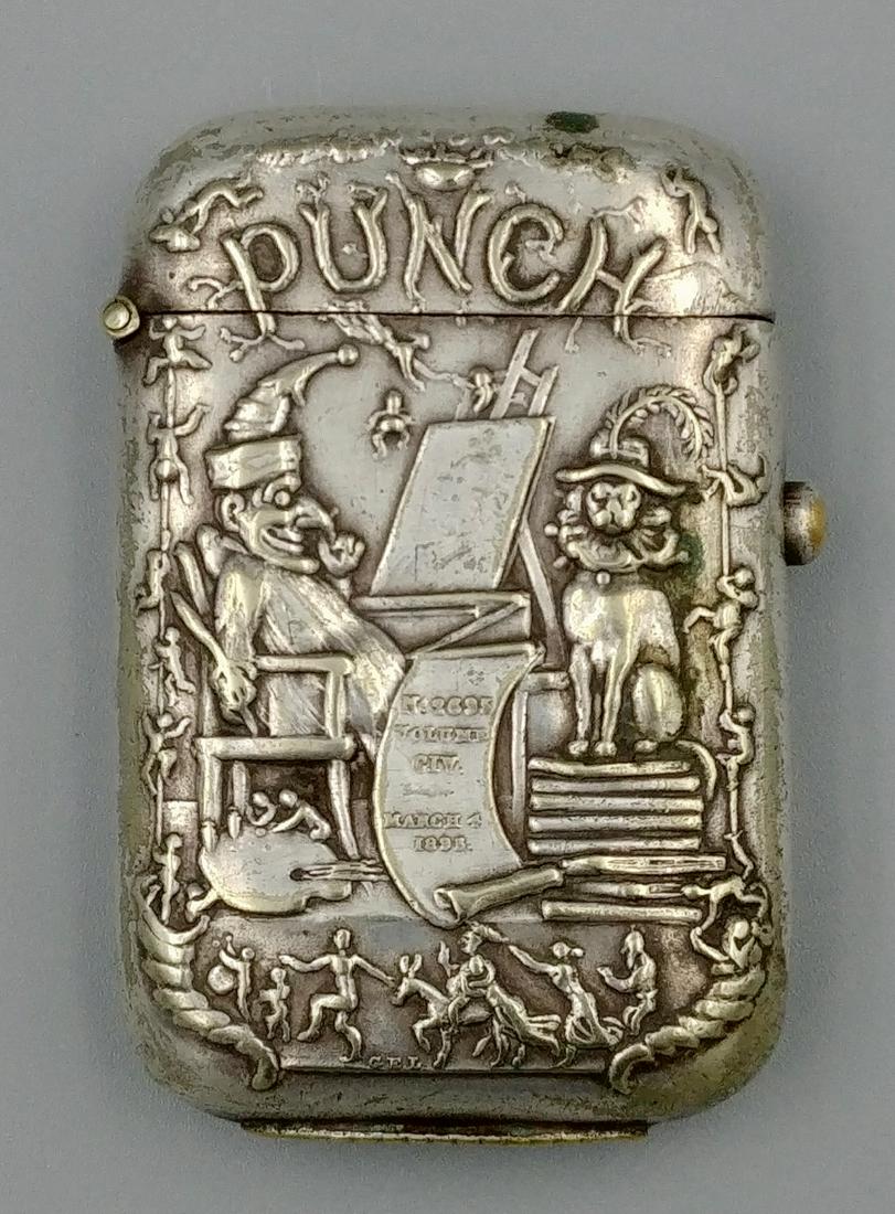 Nickel Plated Punch Match Safe: Front of this safe is finely decorated with Punch, his dog, an easel, scroll (that reads, No. 2695, Volume CIV, March 4, 1895,) painting supplies, and dancers all around. The reverse is plain. Push br