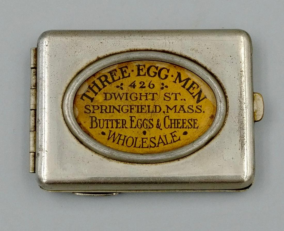 Combination Adv Cigarette Cutter Matchbook Holder: Advertisement for Three Egg Men, 426 Dwight St., Springfield, MASS., Butter, Eggs & Cheese., Wholesale. On the reverse engraved, Three Egg Men, Ask for Hampshire Eggs, T.J. Barr, D.J Harrington, W.A. 