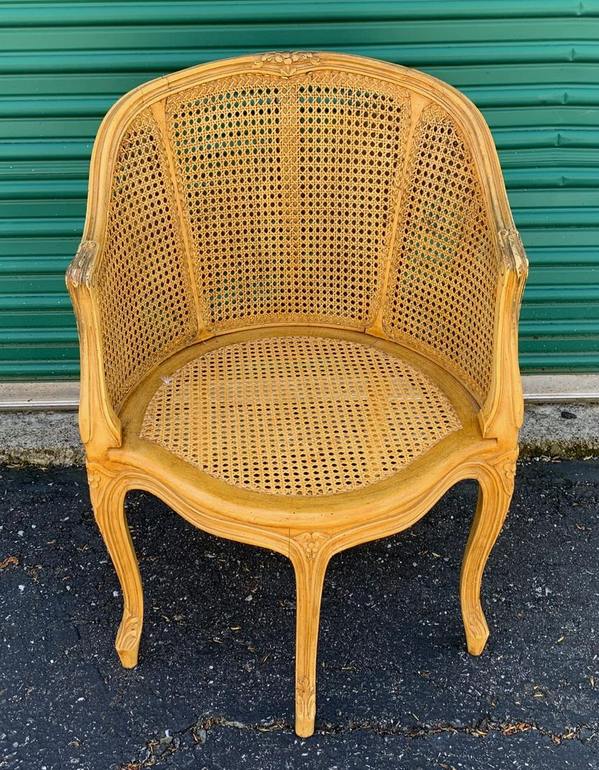French Double Caned Arm Chair: Carved and painted yellow with cushion. 34.25" H x 23.5" W x 20.5" deep
