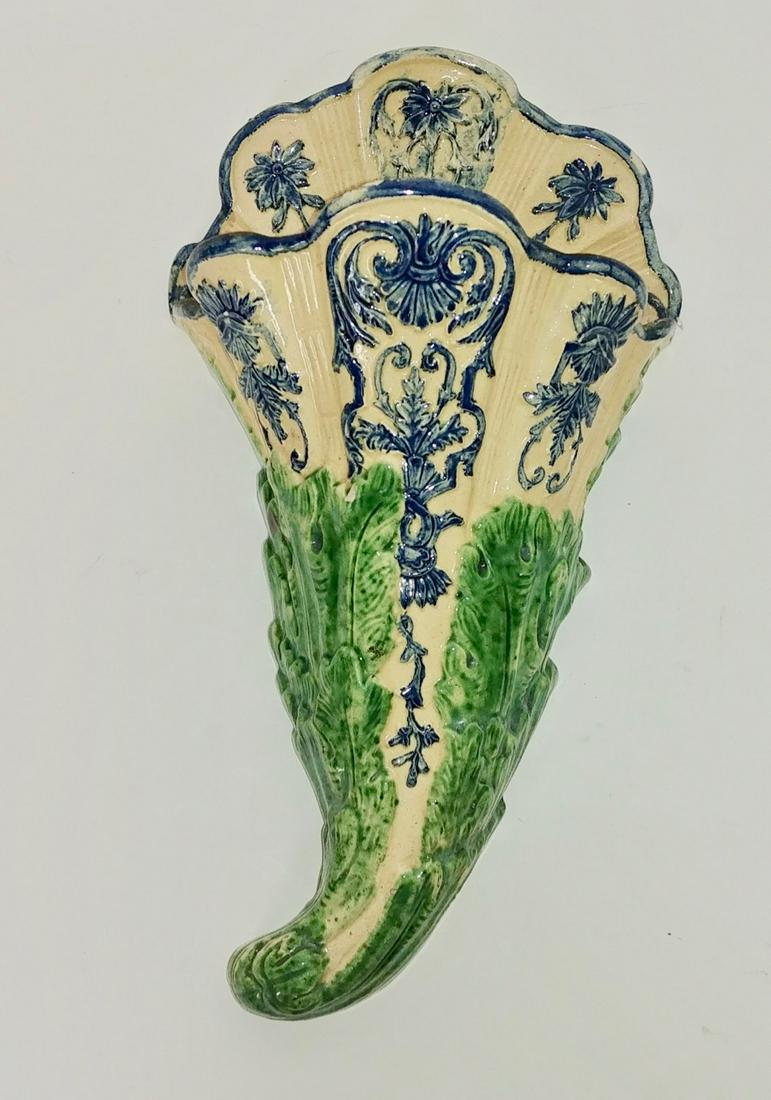 French Majolica Wall Pocket: Impressed St. Honore Les Bales, (Nievre). Cornucopia shaped wall pocket with green and blue decorations on a cream field. Some minor glaze chipping. 12.5" H