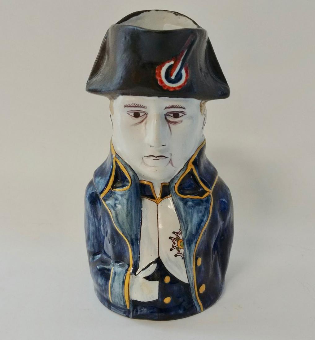 Pottery Napoleon Pitcher: Hand in shirt. Blue maker's mark at the base. Small repaired chip at the left side of his hat. 9" H