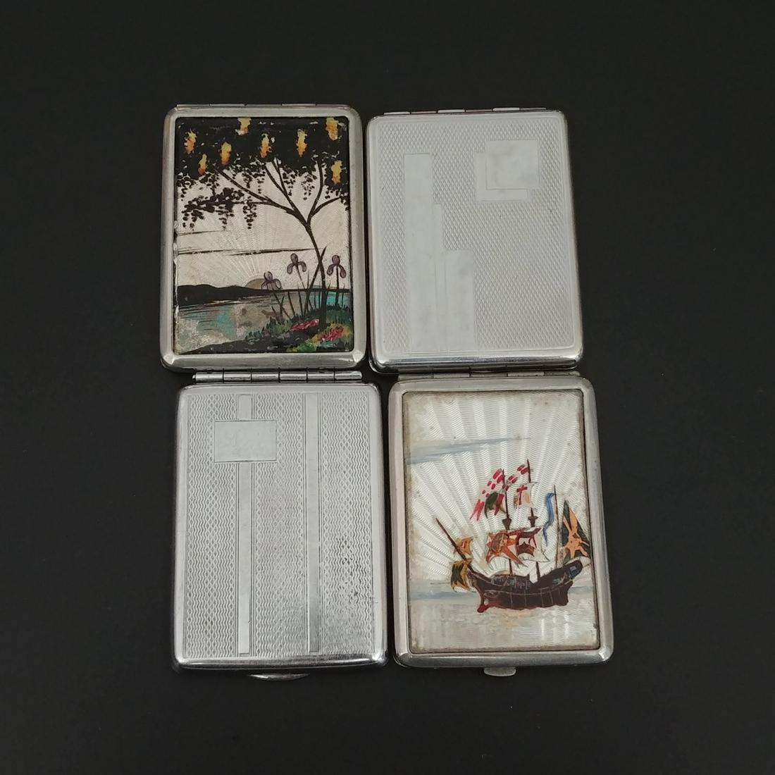 Silver Metal Matchbook Holders (4): English Nautical Butterfly Wing Match Safe. Reverse painted and butterfly wing wooden ship with many flags decorates the front. Patterned reverse. Made in England at the interior. No visible striker. 