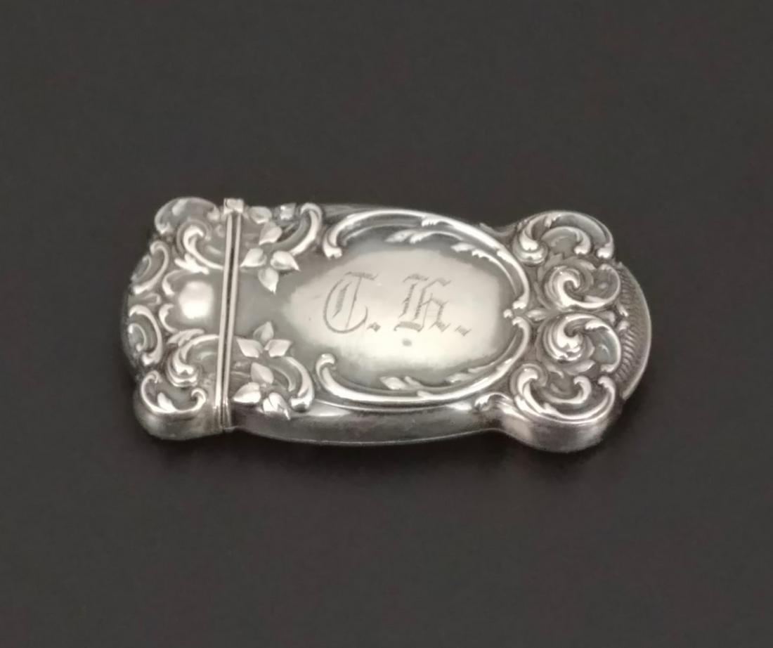Gorham Sterling Silver Match Safe: Flower and scroll embossed. Monogrammed on one side. Other side is blank. Hallmarked for Gorham and marked sterling on one lip and marked R 1100 on the other lip. This piece is split at the side and d