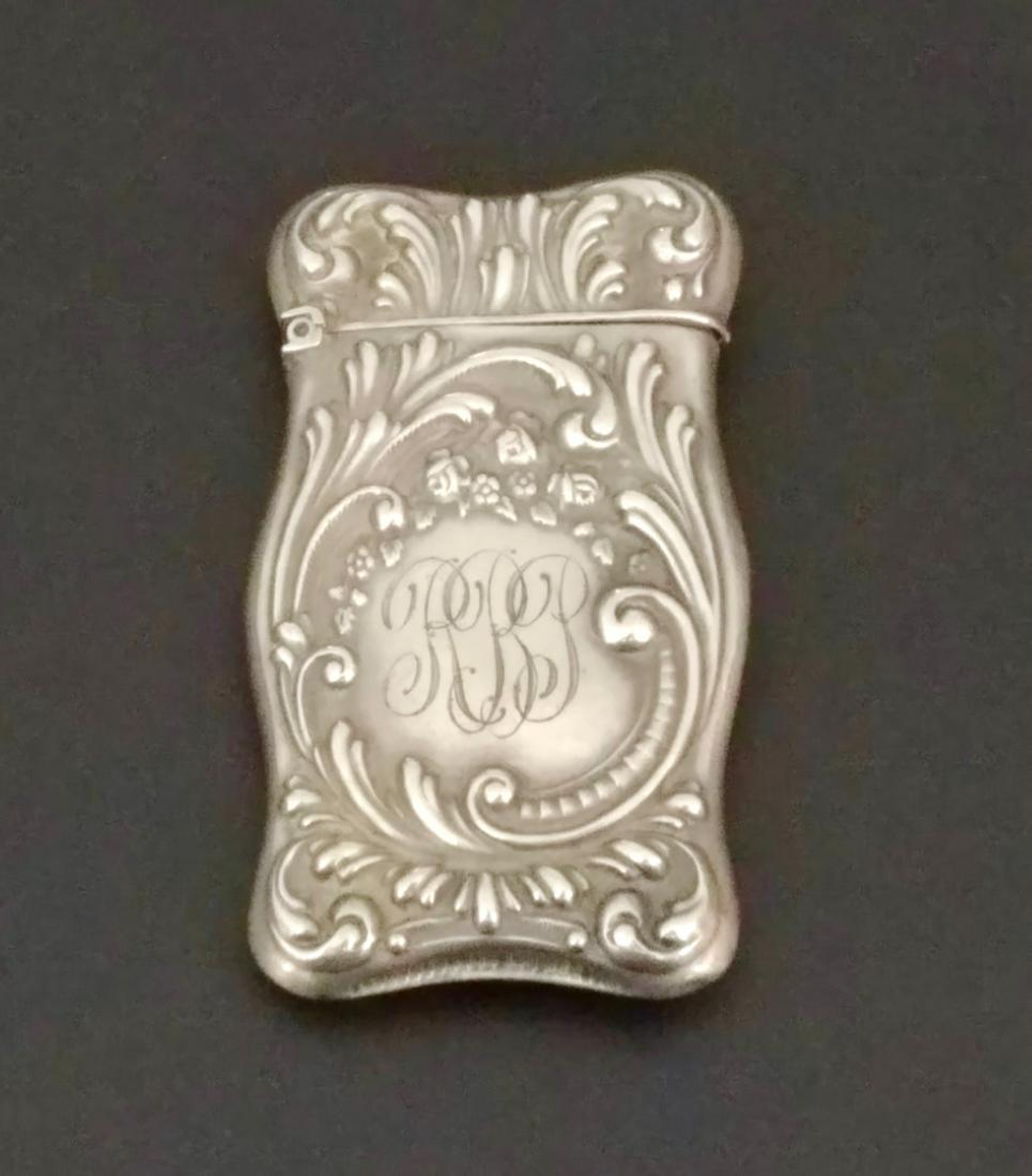 Sterling Silver Match Safe: Scroll and floral embossed. Monogram for RBP. Marked sterling on the lip. Some denting at the reverse. Flip top to open with striker at the base.