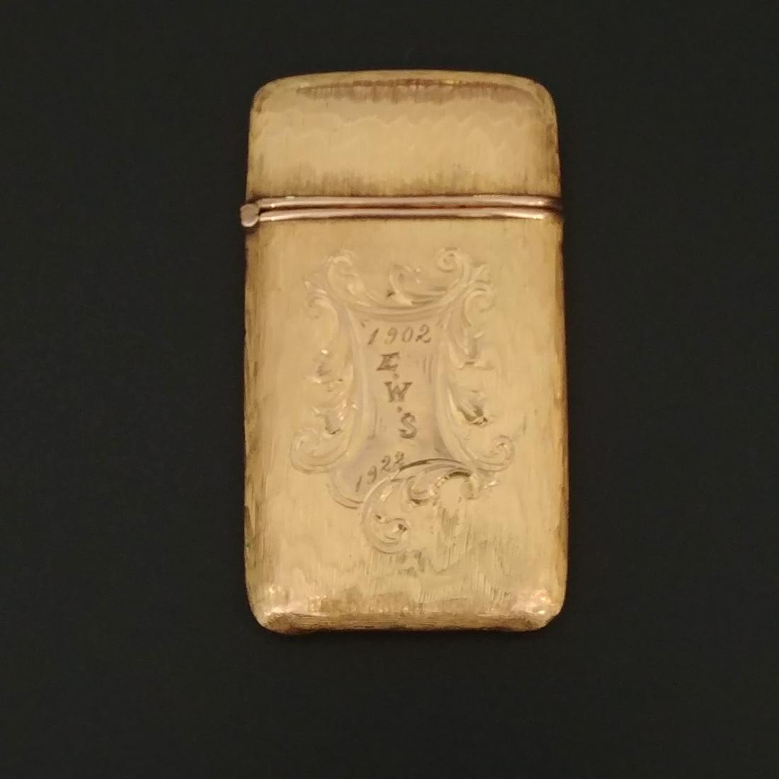 Gold Plated Match Safe: Zig-zag or flame pattern. With monogram for E.W.S. 1902-1922. Flip top with striker at the base.