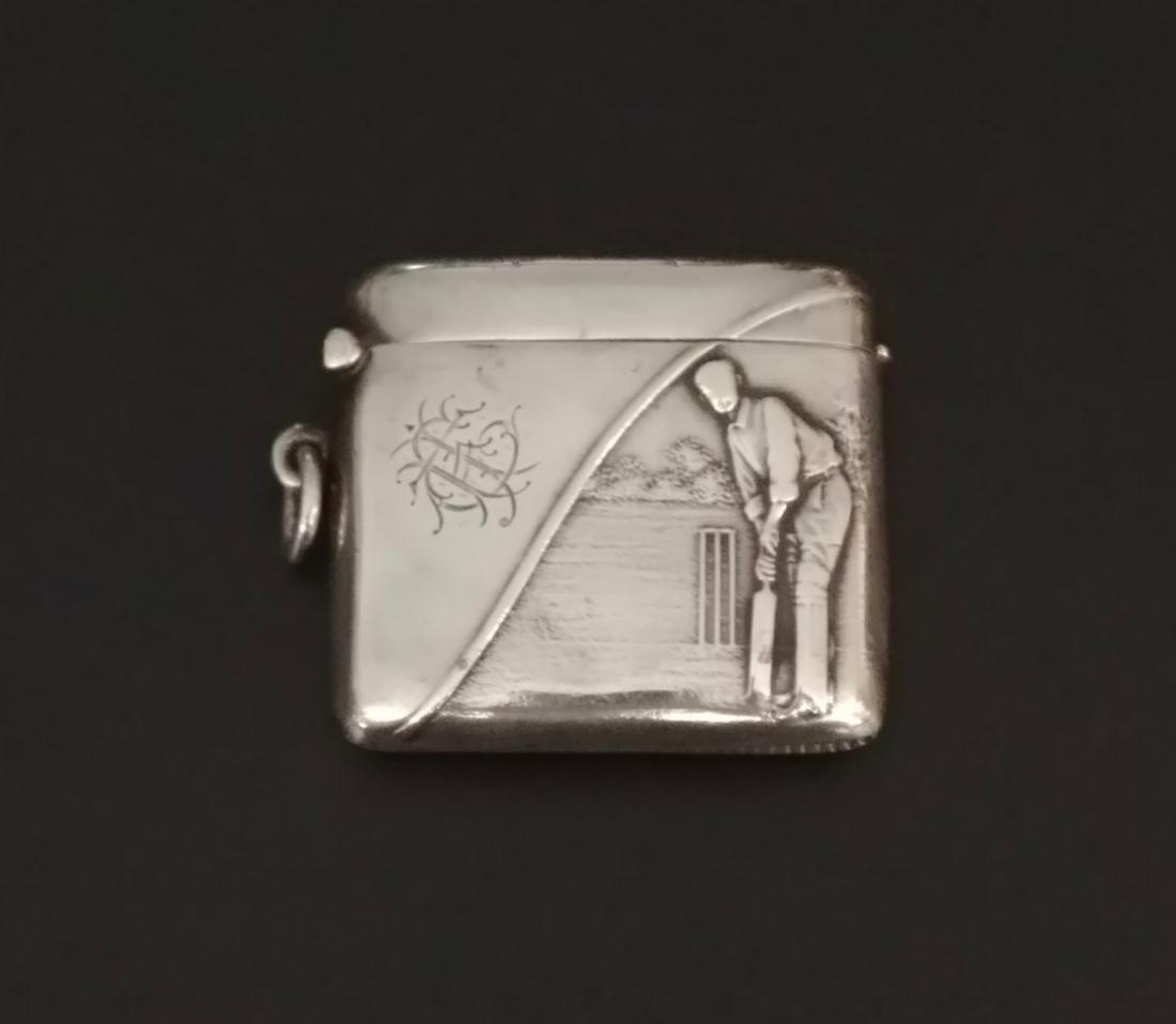 Sterling Silver English Match Safe: Graphic of a man playing Cricket. Hallmarked for 1906 Birmingham, Henry Matthews. Rd. 488019. Flip top with striker at the base. Small dent at the top and on the front. Loop and ring at the side for a