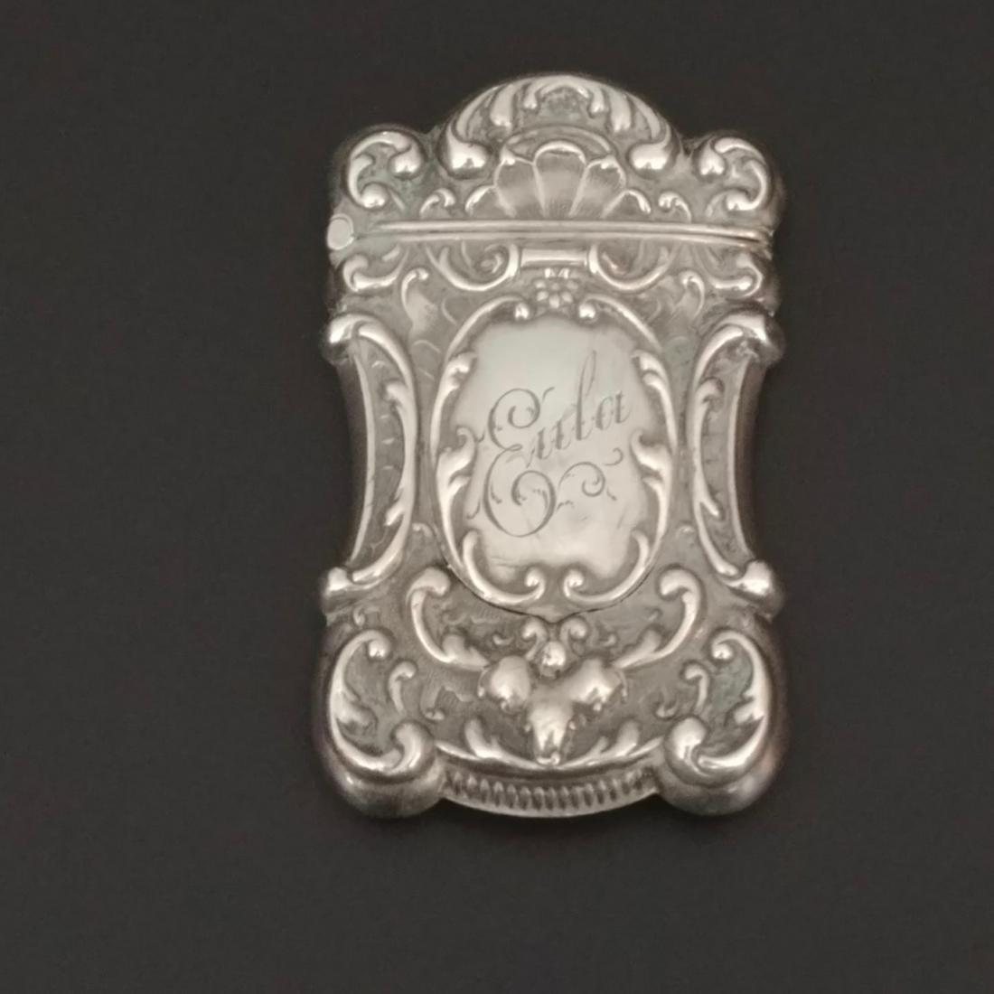 Sterling Silver Mistress Match Safe: Battin & Co., Newark, NJ. Engraved "Eula" at the front and 1904 at the reverse. A tiny button under the name engraving opens central portion of the safe to reveal a secret oval picture frame. Marked S