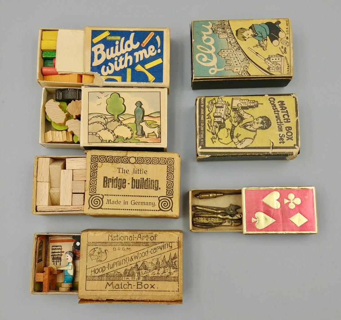 Lot of Trick, Mechanical or Toy Match Boxes: Lot includes a miniature 5 piece tool set; Build with Me! Wooden block set; Match Box Construction Set; Western Germany miniature wooden sheep, dog and shepherd figures; National Art of Hoop Turning &