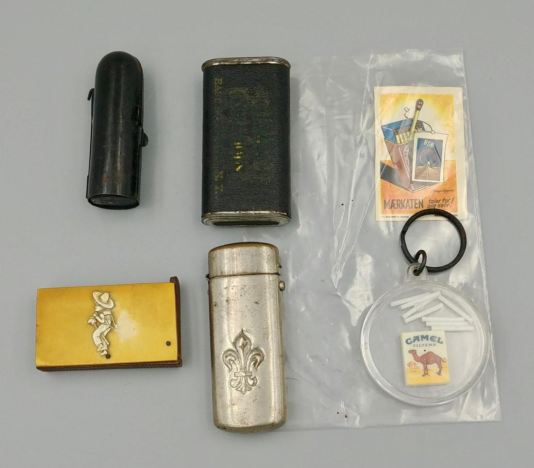 Miscellaneous Match Related Lot (6): Bakelite match safe with young cowboy riding a stick pony. Flip top to open. Striker at the base.; Camel cigarette game on keychain; wax candle in metal case. Appears to attach to something larger.; N