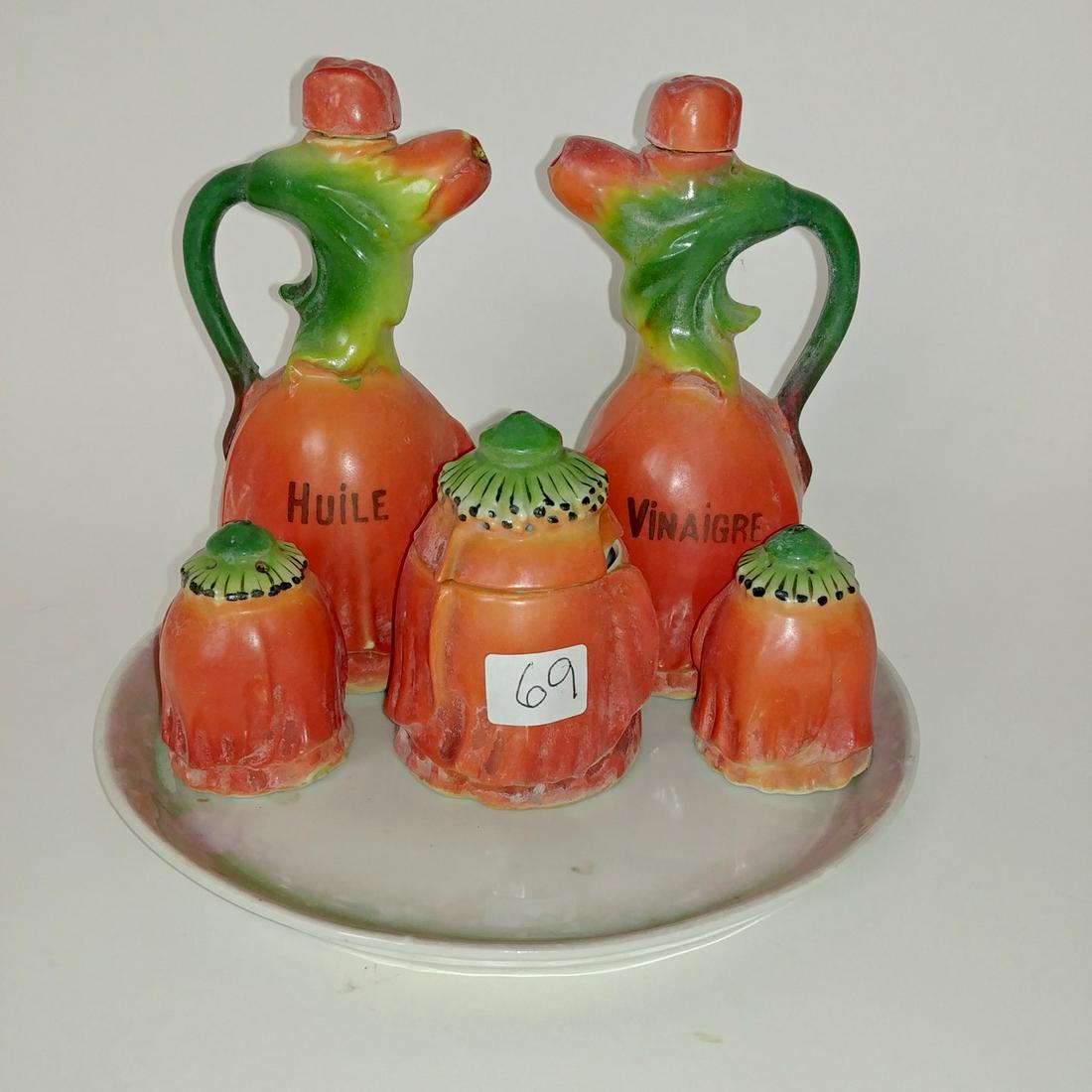 French Pottery Condiment Set on Tray: Orange and green glazed pottery. Huile, vinaigre, mustard pot (no spoon), salt & pepper. Tray does not match. Tray is 7.5" diameter. Oil is 5.75" H.