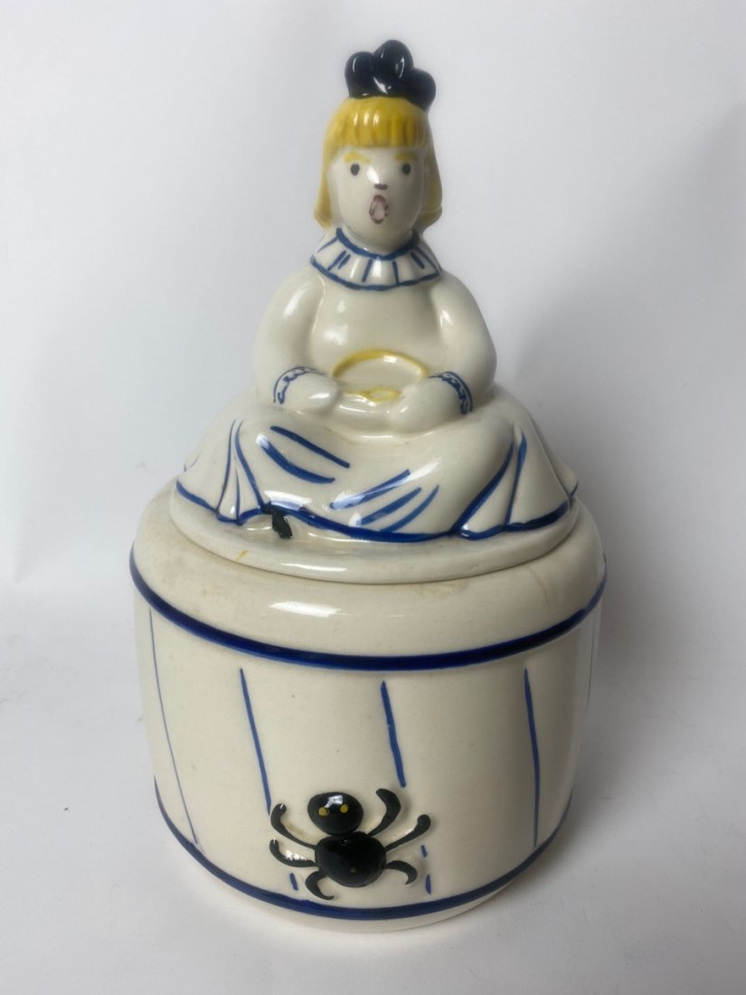 Little Miss Muffet Cookie Jar: Ironstone cookie jar. Little Miss Muffet sits atop the jars as the lid. 7.5" D