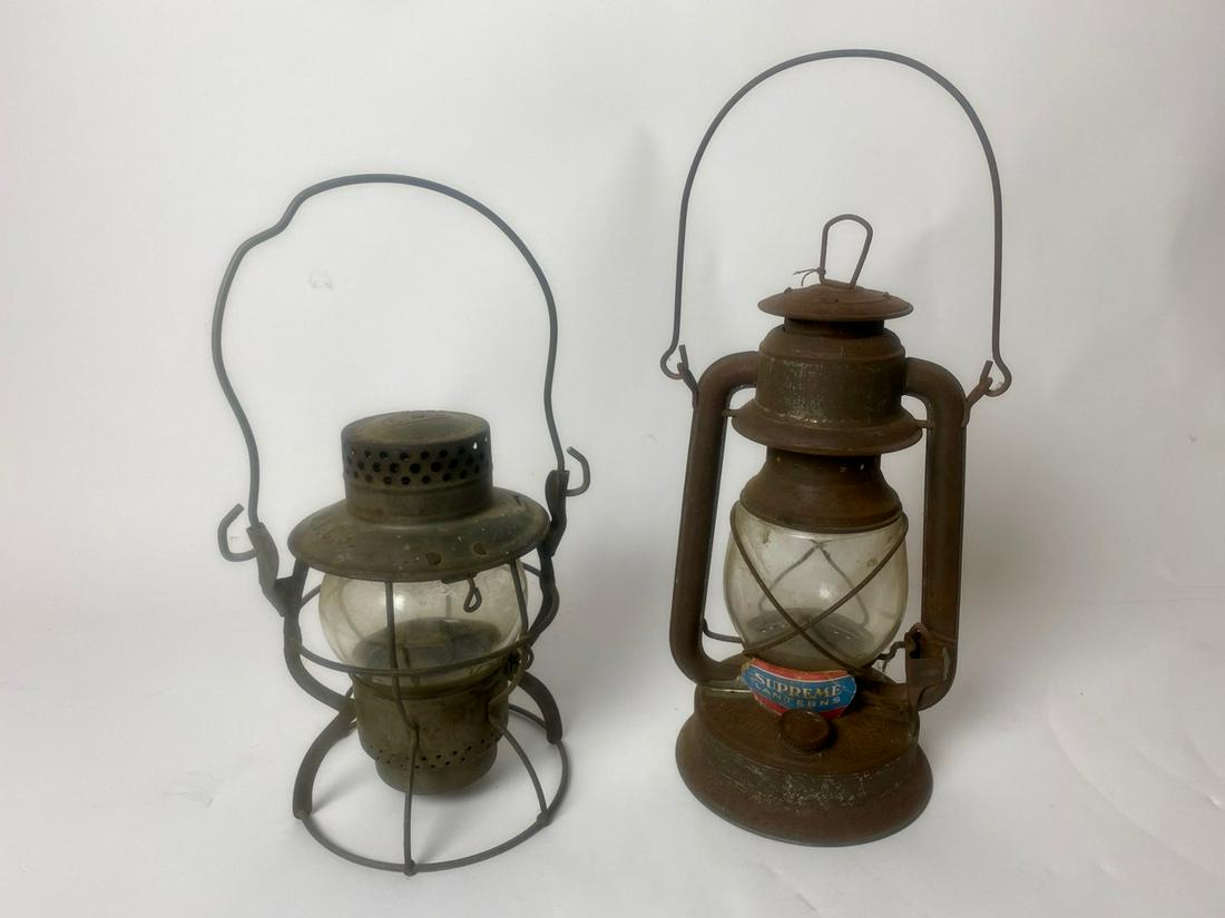 Two Railroad Lanterns - Dietz and Supreme: Dietz is marked N.Y.C.S., #999 Kerosene, New York, USA; Little Supreme lantern with paper label. Embury Mfg. 9" H not inc. handle; 13" H not inc. handle