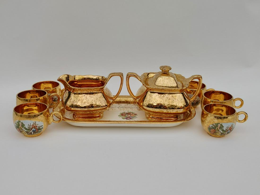 22kt Gold China Cups, Sugar & Creamer, Platter: Lido WS Forge, Made in the USA; Royal China, Warranted 22 kt Gold.; HLC Swing Eggshell USA, Royal China Waarranted 22kt Gold. Plate is 11.5" L; Sugar bowl is 4.25" H; Cup is 2" H
