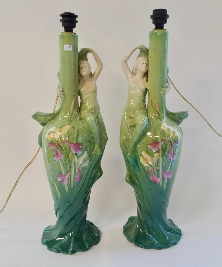 Majolica Figural Table Lamps, Signed: Painted irises with maidens seated on the side of the lamp. With cream colored silk shades. Delphin Massier Vallauris, AM. 21" H