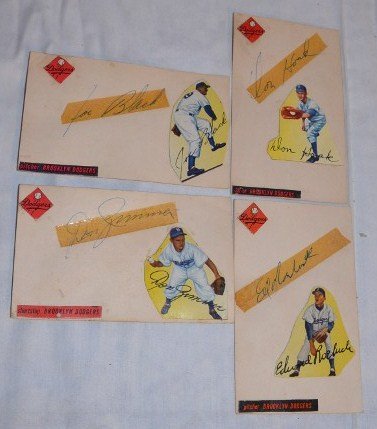 Four Brooklyn Dodgers Autographs: Don Hoak, Don Zimmer, Joe Black, and Edward Roeluck. All on index cards with tape over the signature. Small cut outs pasted on of the player with the Dodgers logo and position played. 3" x 5"