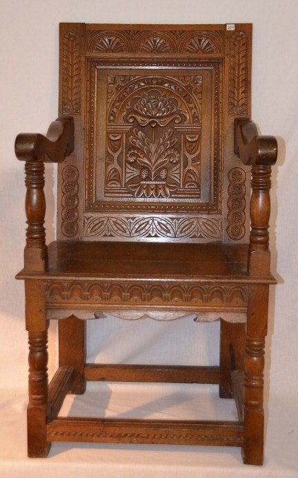 Carved Oak Castle Hall Armchair: Elaborately carved back. Floral center medallion framed by four different carved patterns. Carved apron. 44" high x 22-1/4" wide; seat width is 24"