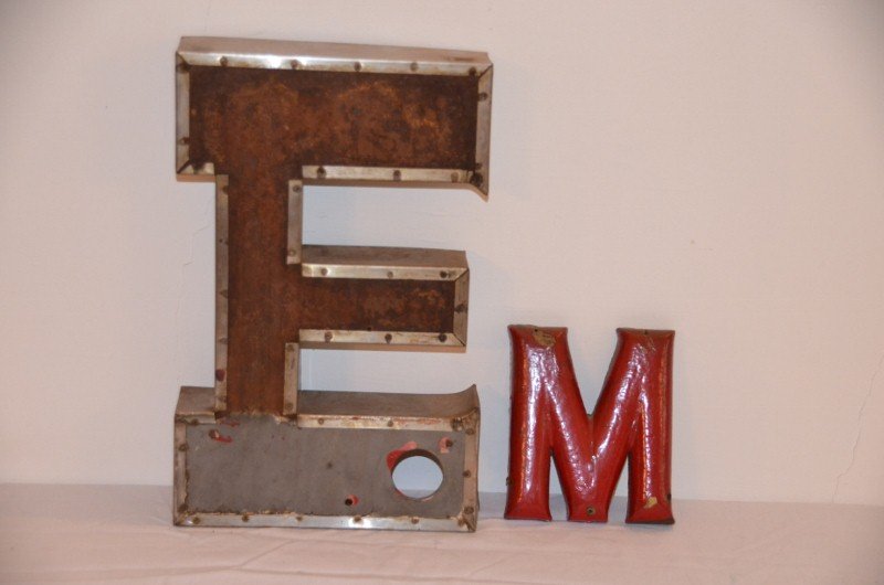 Industrial Steel Letter "E" & Wooden "M": Vintage steel advertising letter "E", interior red paint remnants. Together with a wood carved letter "M". 12" high; 5" high