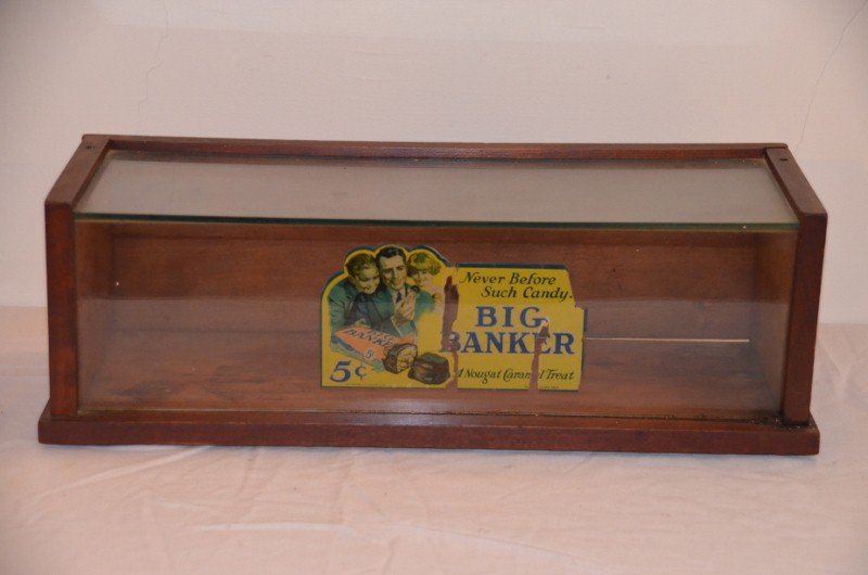 Vintage Big Banker Candy Bar Display Case: A rare mahogany and glass case with interior decal that reads, "Never Before Such Candy. Big Banker. 5 cents. A Nougat Caramel Treat." The Steinau Co., Louisville, KY. Printed in Holland 5852. 18-1/4"