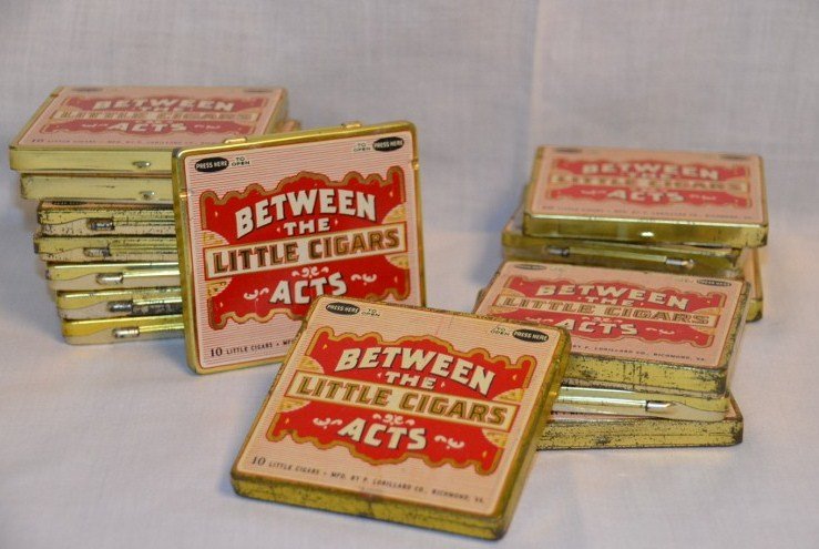Lot of Little Cigar Between the Acts Tins: Sixteen tin cigar cases. Mfd. by P. Lorillard, Richmond, VA. 3" x 3-1/2"