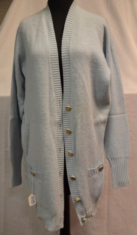Chanel Boutique Blue Cashmere Sweater: Powder blue color. Size 34. Style PO 1937. 100% Cashmere. Two pocket. Six front buttons. NOTE: All clothing & accessories are in "as found in the closet" condition.