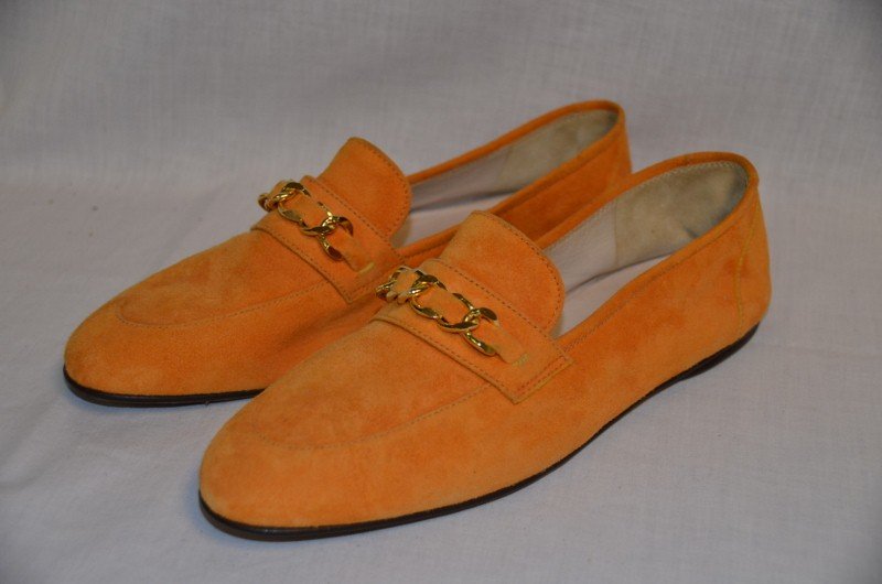 Chanel Suede Loafer Style Shoes: Pumpkin color with chain decoration. Leather soles. Size 39. Style 82330000. NOTE: All clothing & accessories are in "as found in the closet" condition.