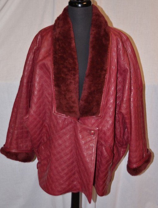 Gianni Versace Leather Coat: Quilted leather. Maroon color. Faux fur at the neck. NOTE: All clothing & accessories are in "as found in the closet" condition.