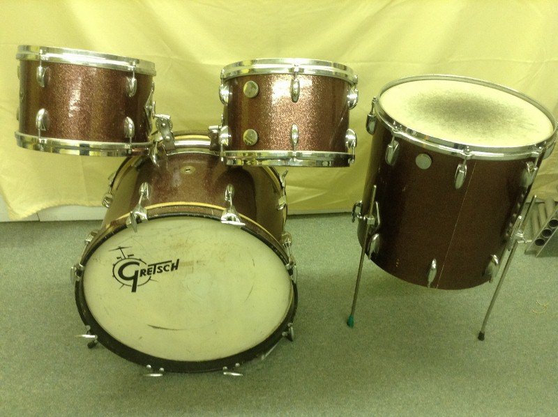 1960's Gretsch Drum Set with Four Drums: Deep red Pearl finish, Vintage 1960's, wood shells. Included are bass drum, floor Tom and 2 top of Bass Drum Tom Toms, and a Yamaha foot pedal.