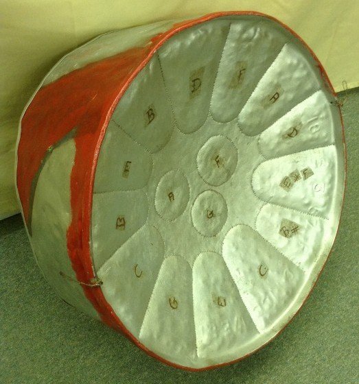 Traditional Caribbean Steel Drum (PAN): Made from 55 gallon drum, painted, two octaves, 13 notes c-a. 22" x 10"