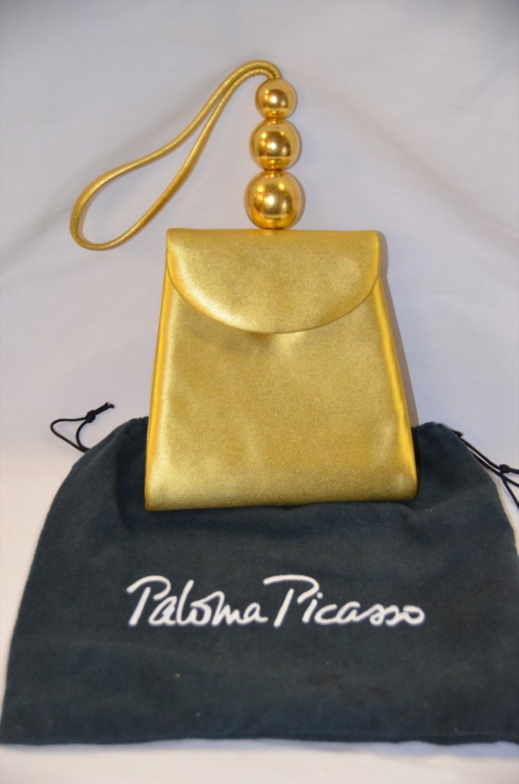 Paloma Picasso Gold Clutch: Cocktail purse. Snap closure. Wrist strap. Three gilt graduated ball decorations. 6" x 6"