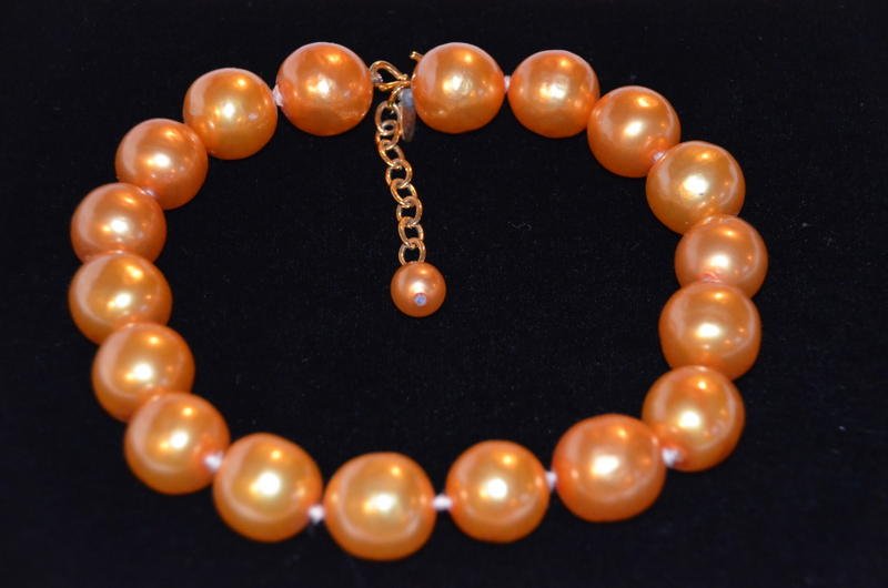 Chanel Vintage Faux Salmon Pearl Choker: Chanel vintage salmon colored faux pearl choker. 18 oversized faux pearls. Gold tone chain extension with small pearl at the end. Marked Chanel, Made in France, with Chanel logo and he numbers 2 and 5