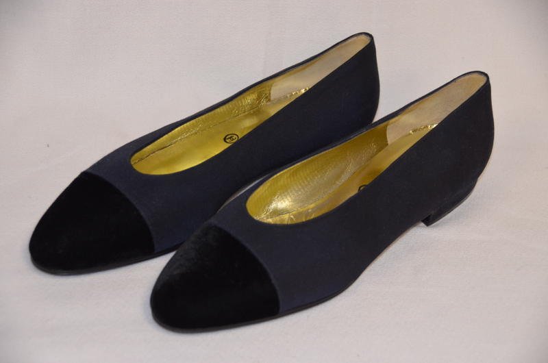 Vintage Chanel Black Flat Shoes - Unused: Faile and velvet black Chanel flat shoes. Golden interior with Chanel, Made in Italy. They are stamped 37-1/2, Made in Italy, Chanel at the underside.