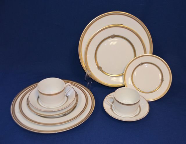 Two Christofle Paris Placesettings - Ruban: Five piece place setting including a dinner plate; luncheon plate; bread plate; cup and saucer. Silver and gold decorated. Marked Special lave vaisselle France.10" dia.; 8-1/2" dia.; 6-3/8" dia; 5-3/4