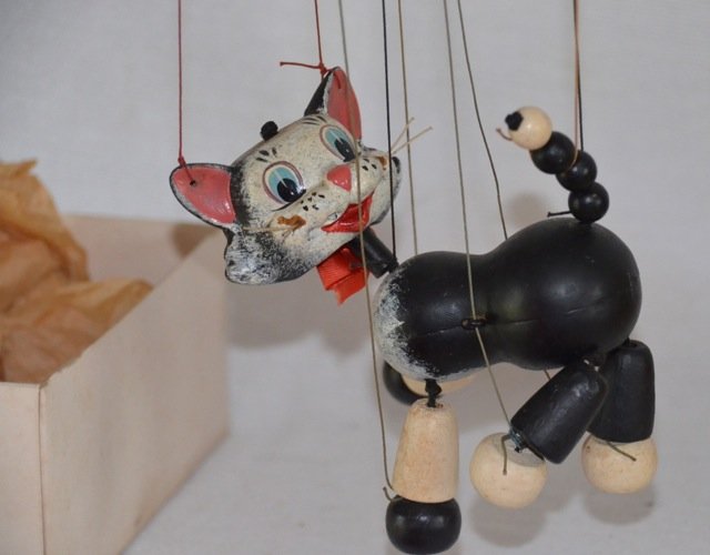 Pelham English Puppet of a Cat: In original box with original instructions of use. Black cat puppet with strings. Box marked Pelham puppets, Marlborough Wilts, Handmade puppets for children with fully illustrated instructions. Stand