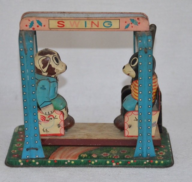 Tin Mechanical Swing Toy with Bears: Marked S.Y., Made in Japan. Two bears go back and forth on a single two seater swing. Small repair to a hinge at the base. 5-1/2" high