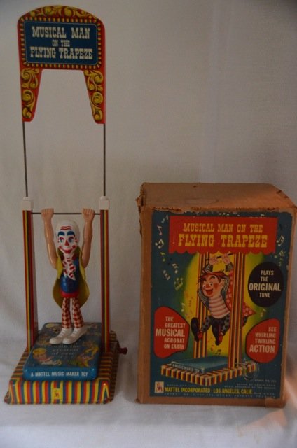 Mattel Music Maker Tin Toy with Clown: Mechanical toy Musical Man on the Flying Trapeze. He floats through the air with the greatest of ease. Mechanical mechanism not working so no music, no clown doing flips. Los Angeles, Calif. In origin